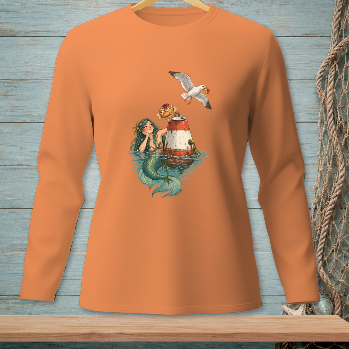 Mermaid with a buoy and a seagull holding a donut, on an orange long-sleeve shirt.