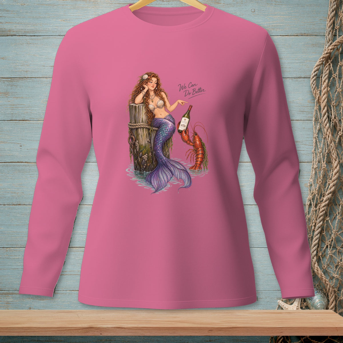 Mermaid and lobster graphic with text "We Can Do Better" on pink long-sleeve shirt.