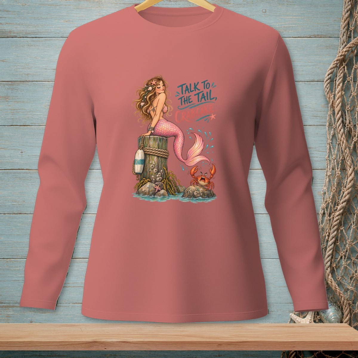 Long sleeve salmon shirt with a mermaid, crab, and text "Talk to the tail, crab."