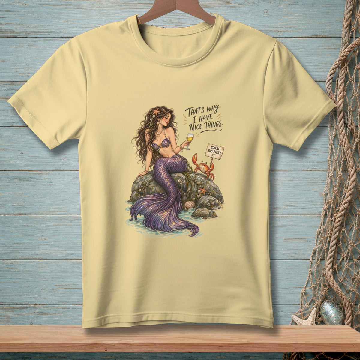 T-shirt with mermaid sitting on a rock with a crab and text.