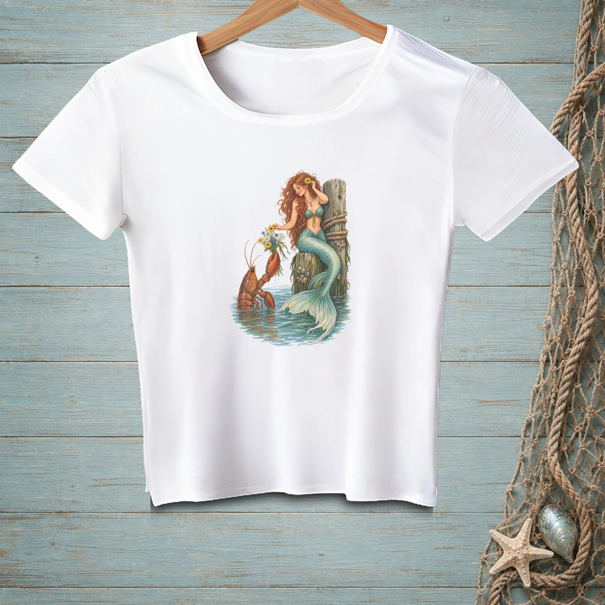 White t-shirt with illustration of a mermaid and lobster holding flowers.