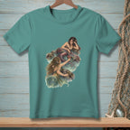 Two mermaids resting on rocks in the water, artwork on a teal t-shirt.