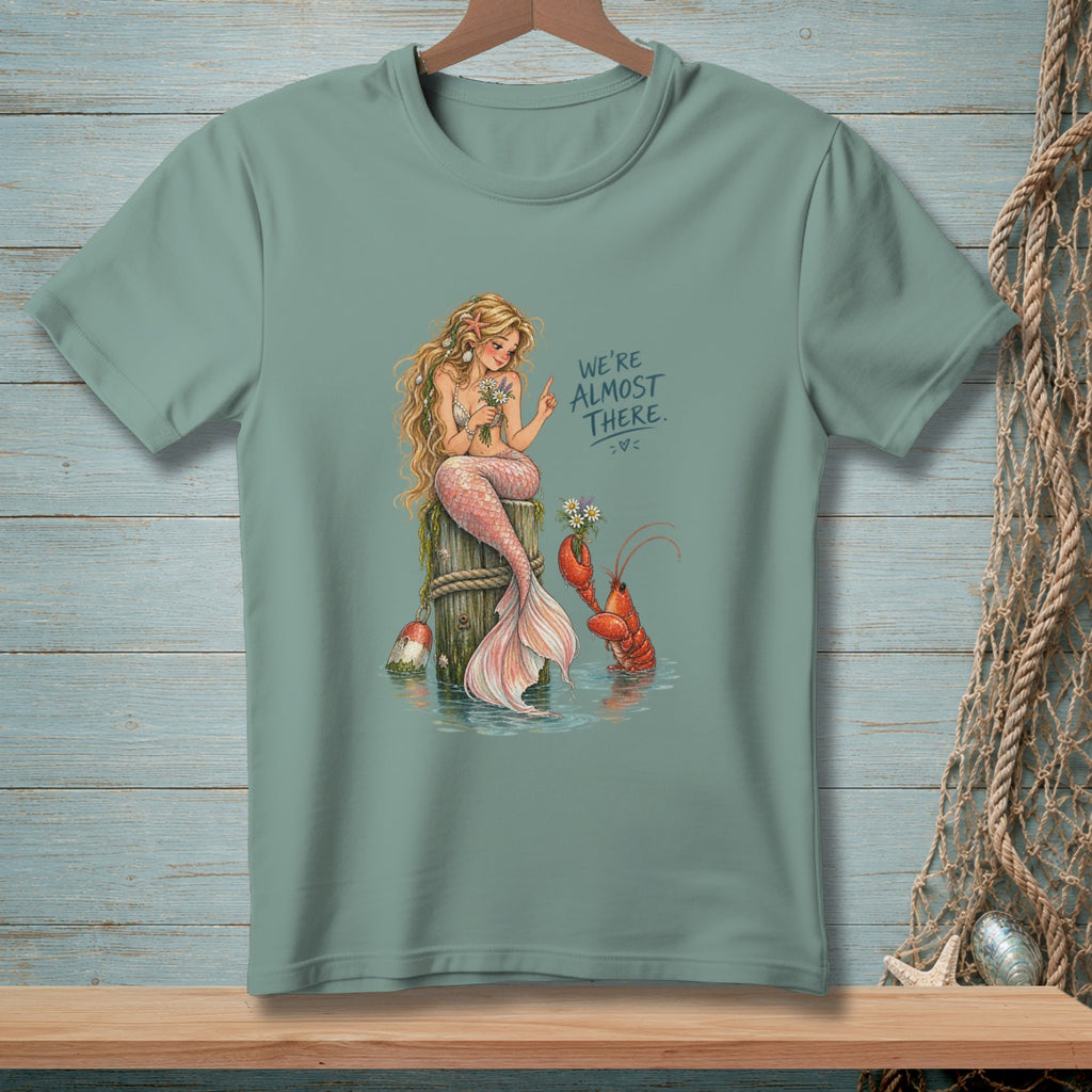 Mermaid and lobster with flowers, text "We're Almost There."