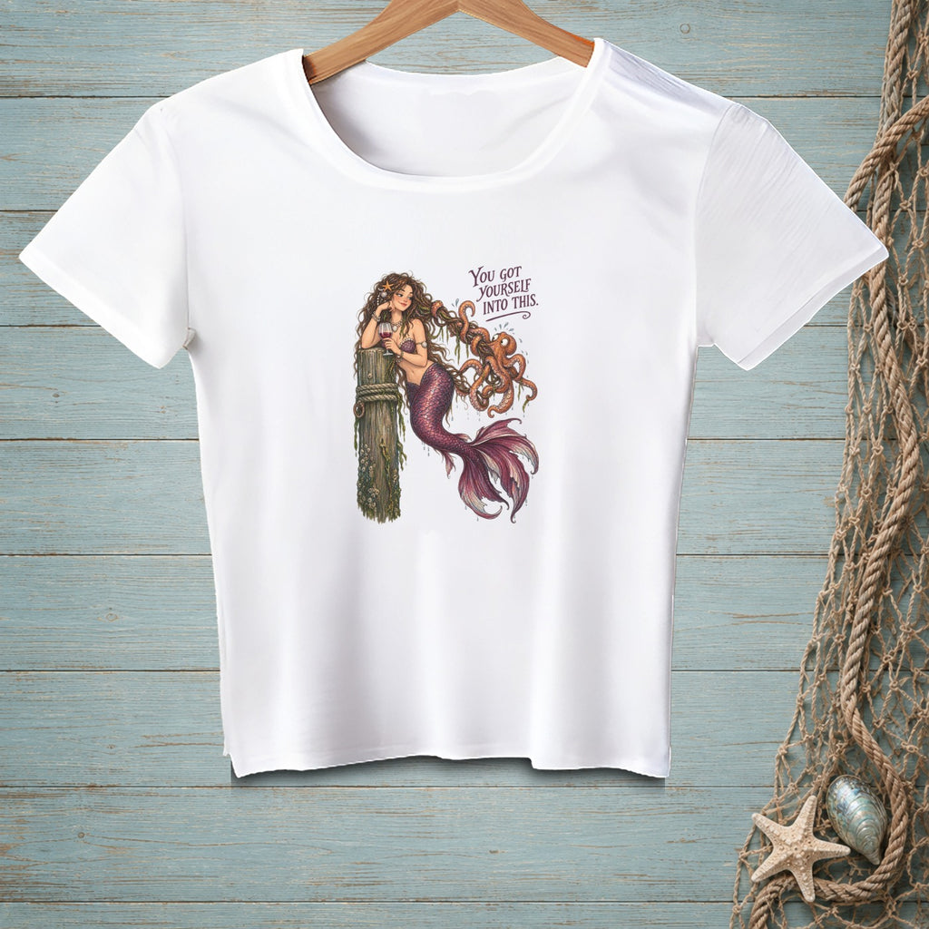 White t-shirt with a mermaid and octopus graphic and text.