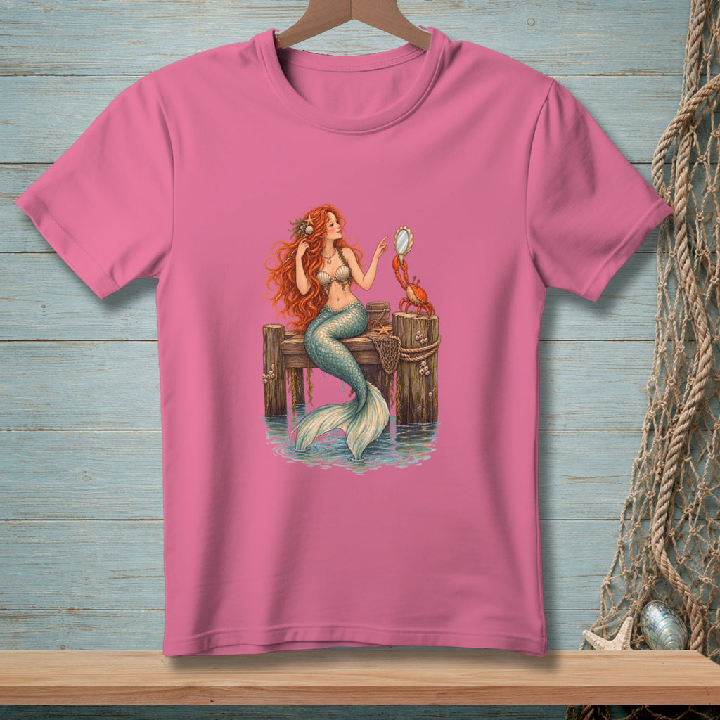 Pink t-shirt with a mermaid and crab on a dock illustration.