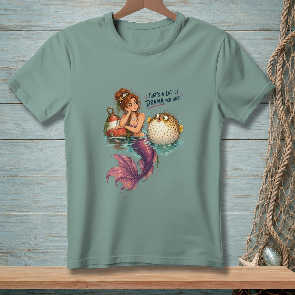 Mermaid with pufferfish, text "That's a lot of drama per inch."