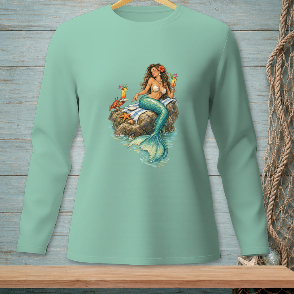 Mermaid with drinks and crab on a rock beside the sea.