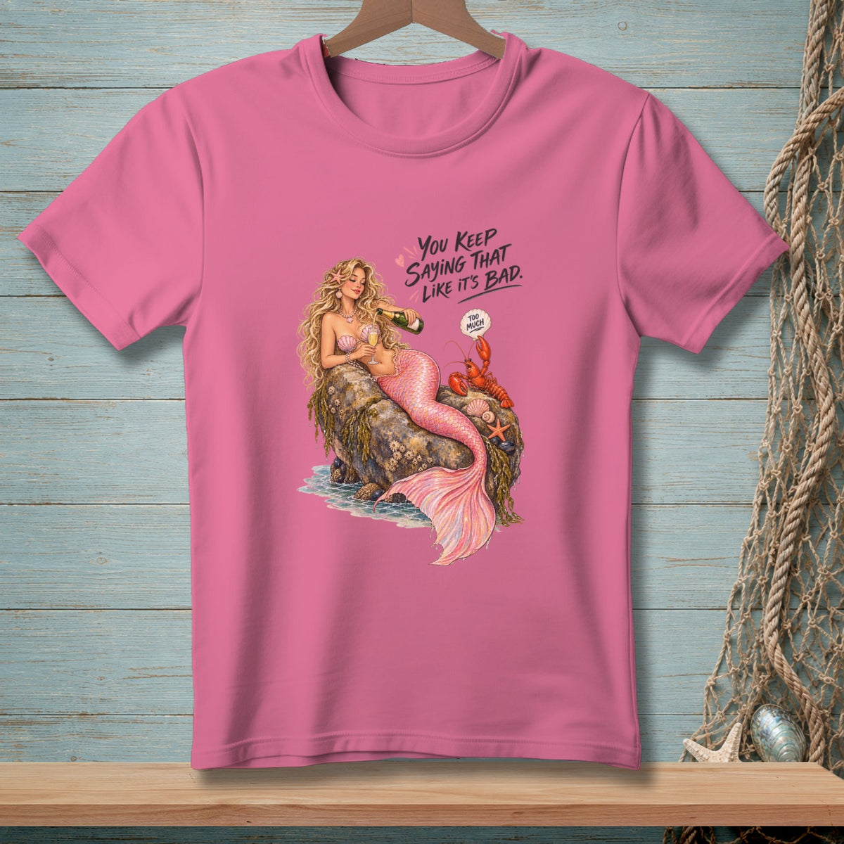 Pink t-shirt with a mermaid pouring champagne, a lobster, and text.