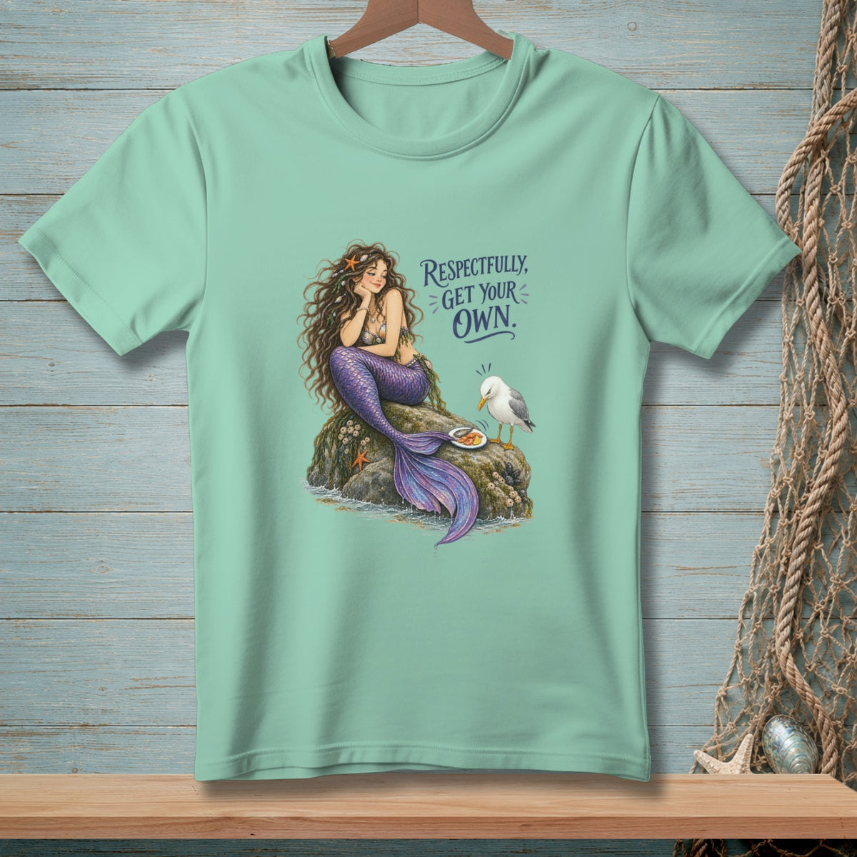 Mermaid with purple tail sitting on rock with food, seagull, text "Respectfully, Get Your Own."