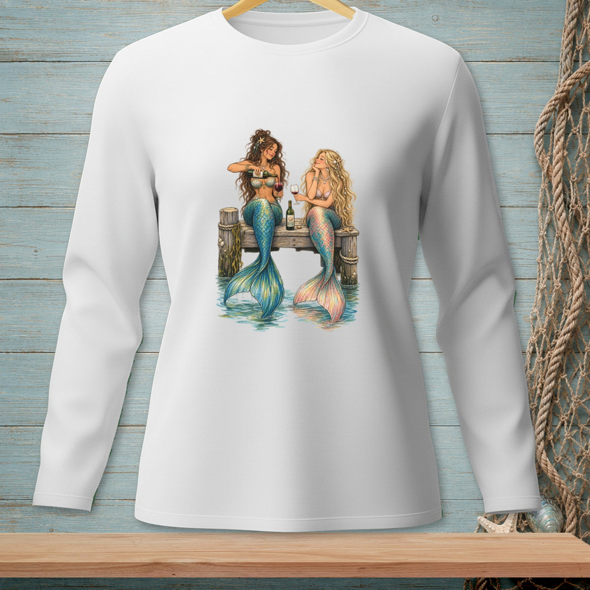 Two mermaids sit on a dock, one pouring wine for the other.