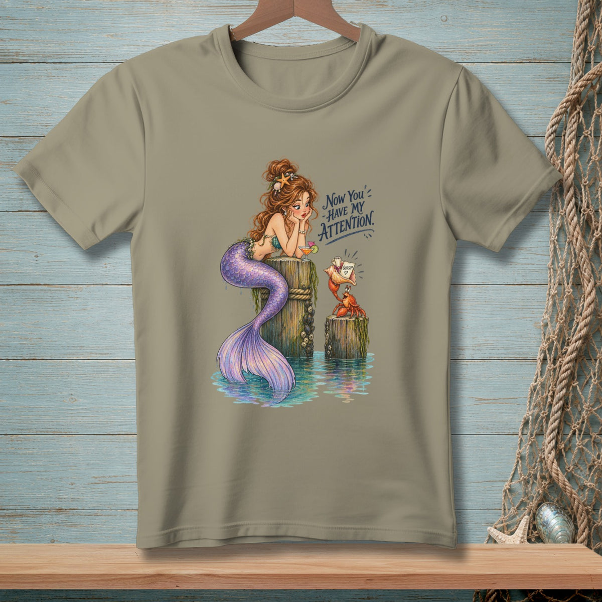Mermaid and crab on dock with text "Now You Have My Attention".