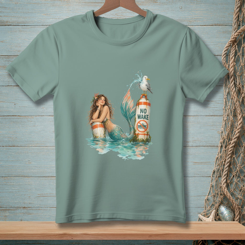 Mermaid leaning on a buoy with "NO WAKE" sign, seagull on top.