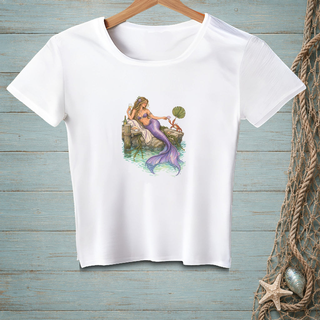 White t-shirt with illustration of a mermaid relaxing on a dock.