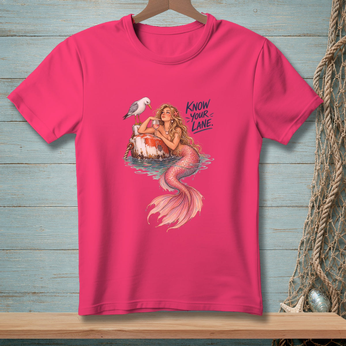 Pink t-shirt with a mermaid, seagull, and text that reads "Know Your Lane."