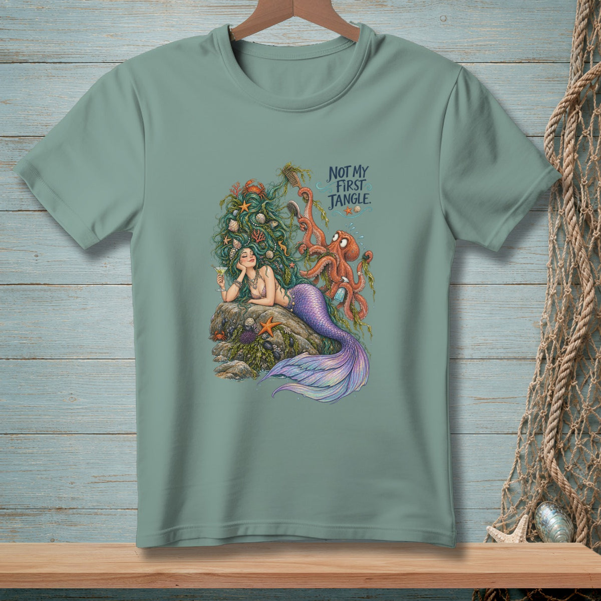 Mermaid with octopus, text "Not My First Jangle" on a teal t-shirt.