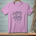 Purple t-shirt with "Currently Not Caring" text and a mermaid tail graphic.
