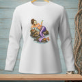 White long-sleeve shirt with a mermaid relaxing on rocks, holding a drink.
