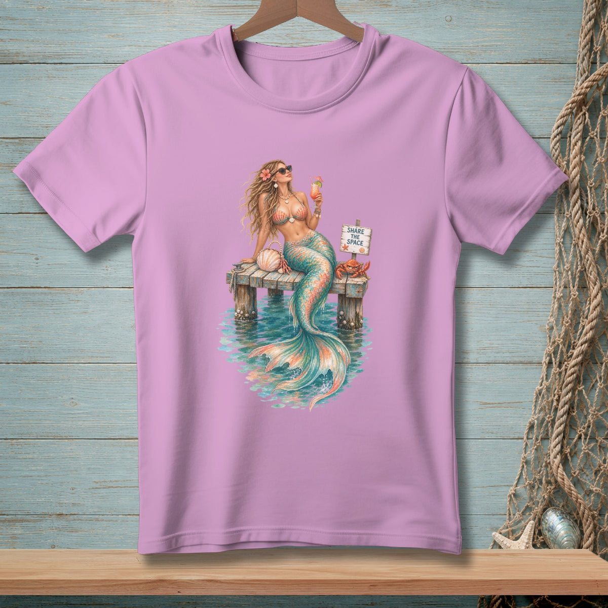 A mermaid holds a drink on a dock with a "Share the Space" sign and crab.