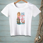 White t-shirt with a graphic of a mermaid and crab and the text "Talk to the tail, crabcake."