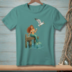 Mermaid sits on a pier with a cocktail, while a seagull flies by holding food.