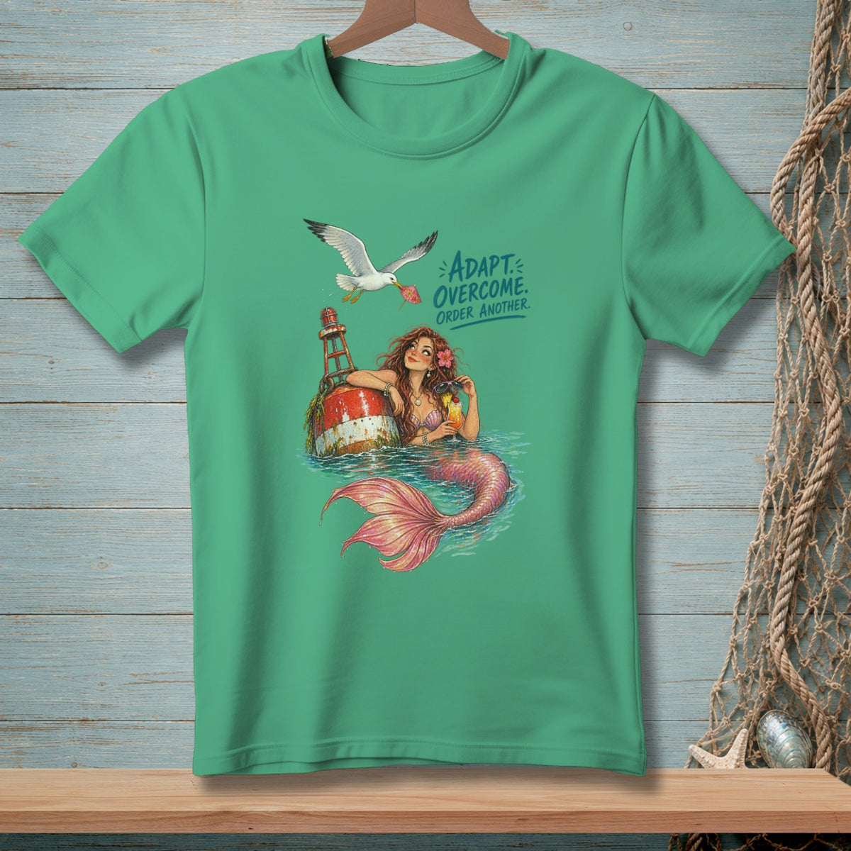 Mermaid on buoy with seagull holding umbrella, text reads "ADAPT. OVERCOME. ORDER ANOTHER."