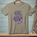 Tan t-shirt with purple text "I Have a Tail and an Attitude" and mermaid tail graphic.