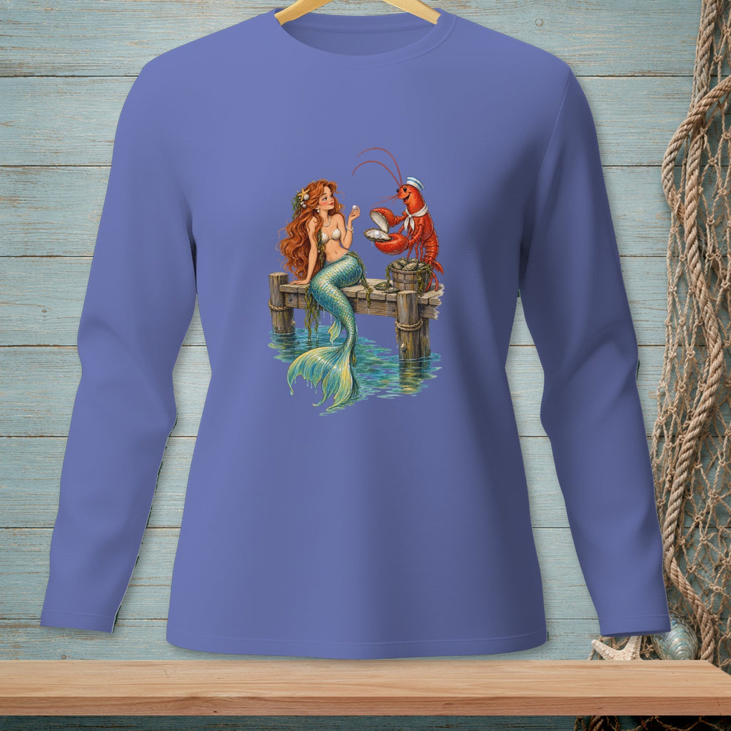 Mermaid and lobster examine a pearl on a dock beside shimmering water.