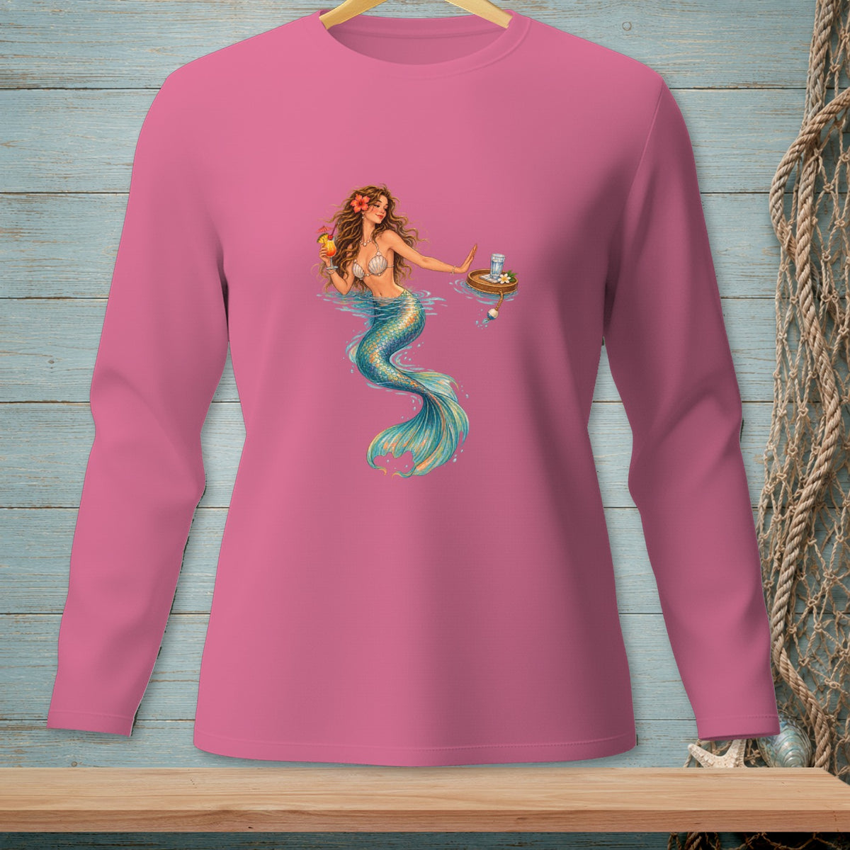 Pink long-sleeve shirt with a graphic of a mermaid holding a drink.