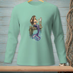 Mermaid with purple tail combing hair with a mirror on a wooden pier.