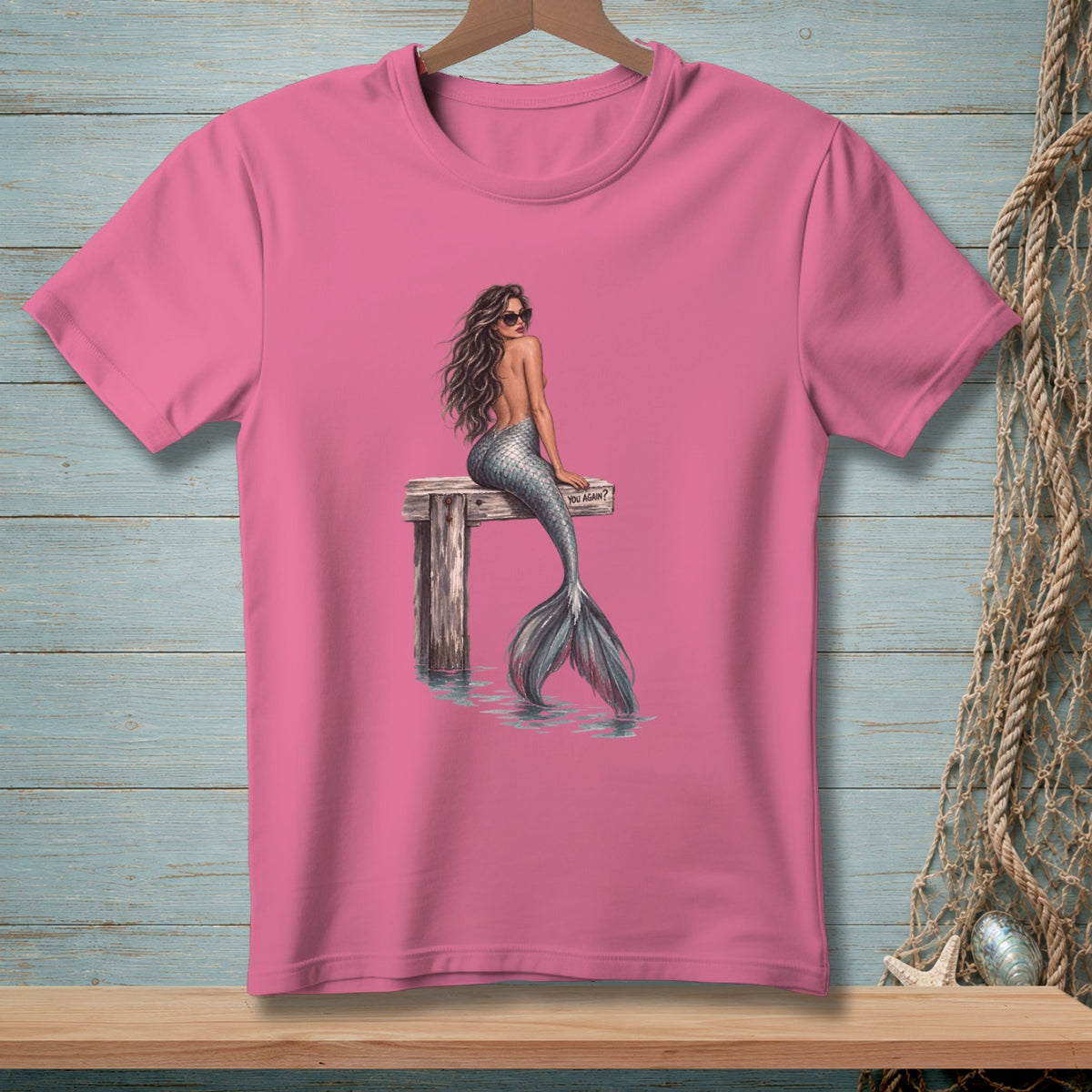 Pink t-shirt with mermaid wearing sunglasses on dock, text reads "YOU AGAIN?".