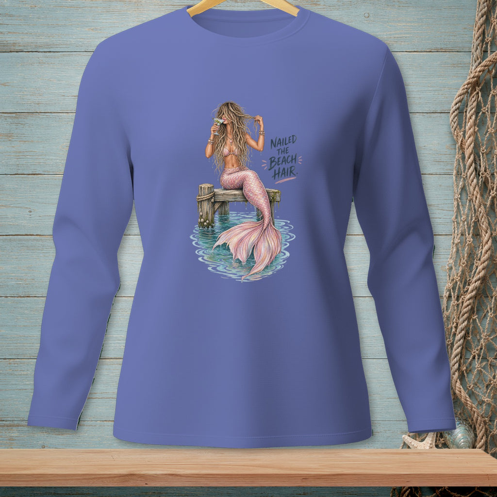 Mermaid with pink tail and drink on dock, text "Nailed the beach hair."