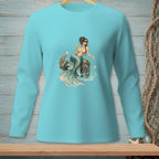 Teal long-sleeve shirt with a mermaid graphic holding a drink on a rock.