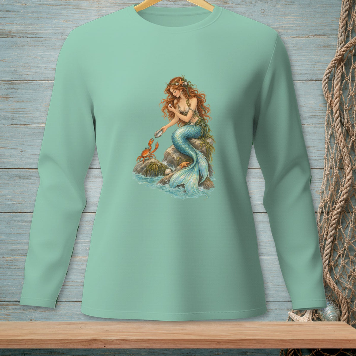 Mermaid sitting on rocks, interacting with a crab and holding a pearl.
