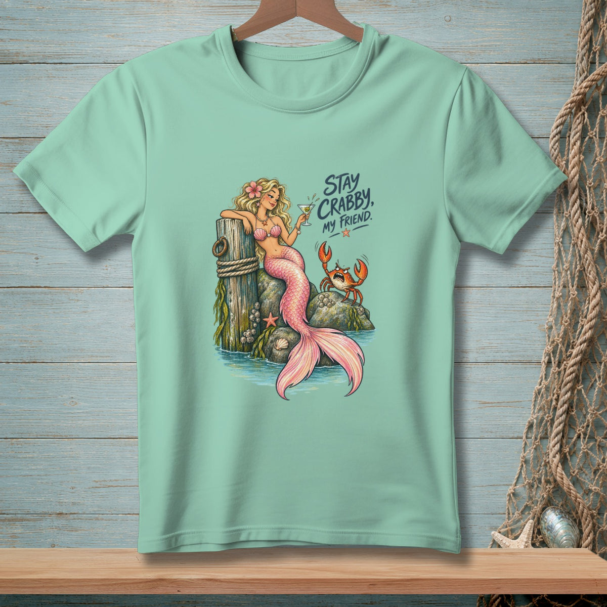 Mermaid with a drink and a crab on rocks, with text "Stay Crabby, My Friend."