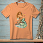 Peach t-shirt with a mermaid, crab, and cocktail on a rock.
