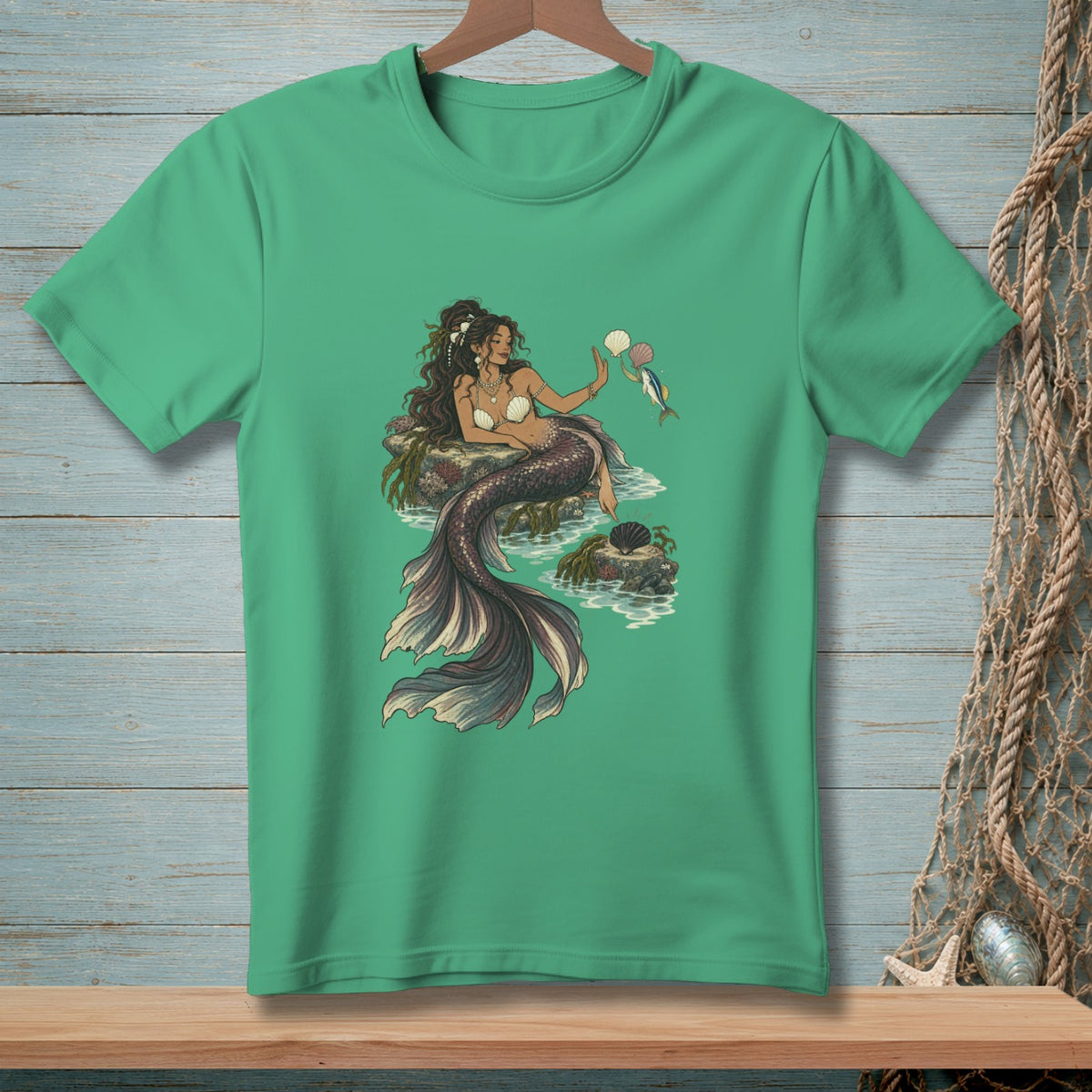 Green t-shirt featuring a detailed illustration of a mermaid with a pearl and a fish.