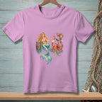 Illustration of a mermaid with an octopus holding a bouquet and purse on a lavender t-shirt.