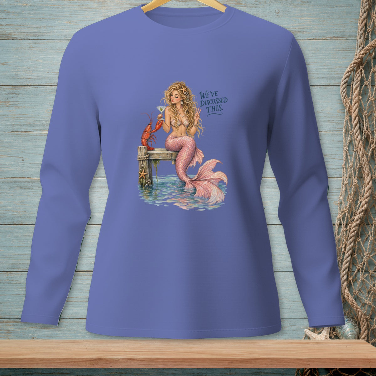 Mermaid with lobster and cocktail on dock, text "We've discussed this."