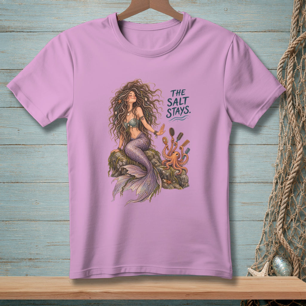 Mermaid sitting on rock with octopus and comb, text "The Salt Stays".