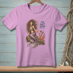 Mermaid sitting on rock with octopus and comb, text "The Salt Stays".