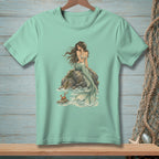 Mint green t-shirt with mermaid on a rock and a crab in the waves.