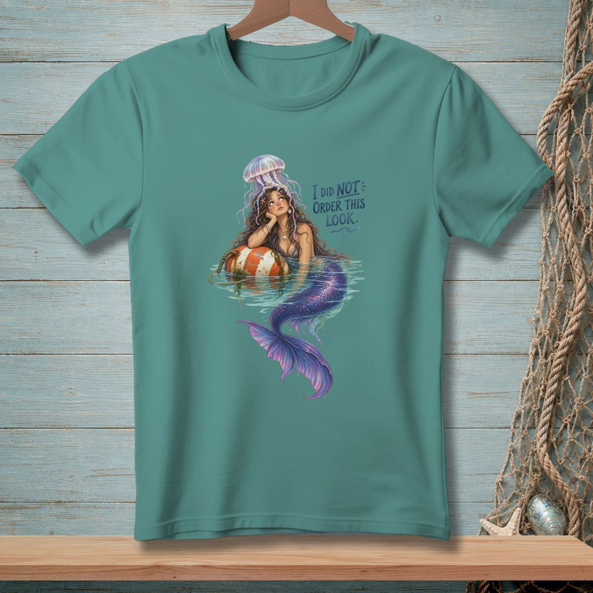 Teal t-shirt with a mermaid and jellyfish graphic, text reads "I DID NOT ORDER THIS LOOK."