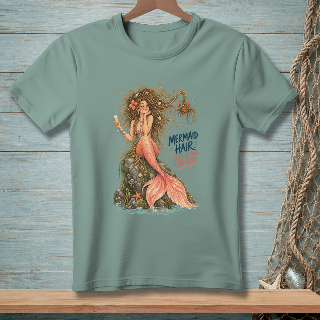 Mermaid sitting on a rock with champagne, text reads "MERMAID HAIR ENTER AT YOUR OWN RISK".