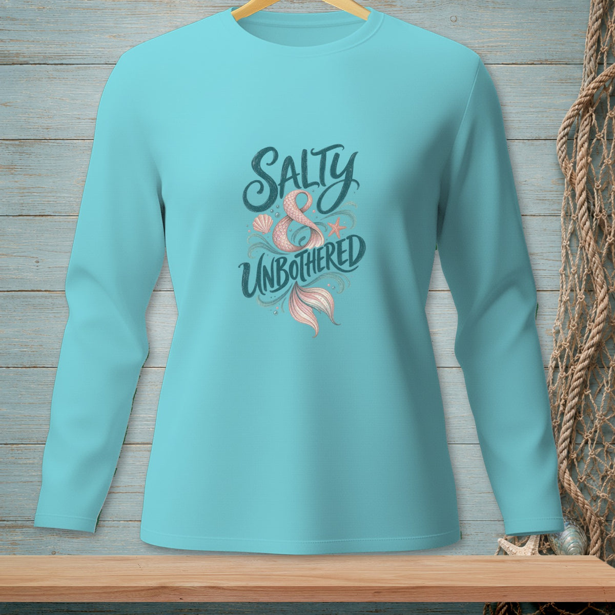 Turquoise long-sleeve shirt with "Salty & Unbothered" and mermaid tail design.