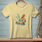 Light yellow t-shirt with a detailed illustration of a mermaid and a seagull on a rock.