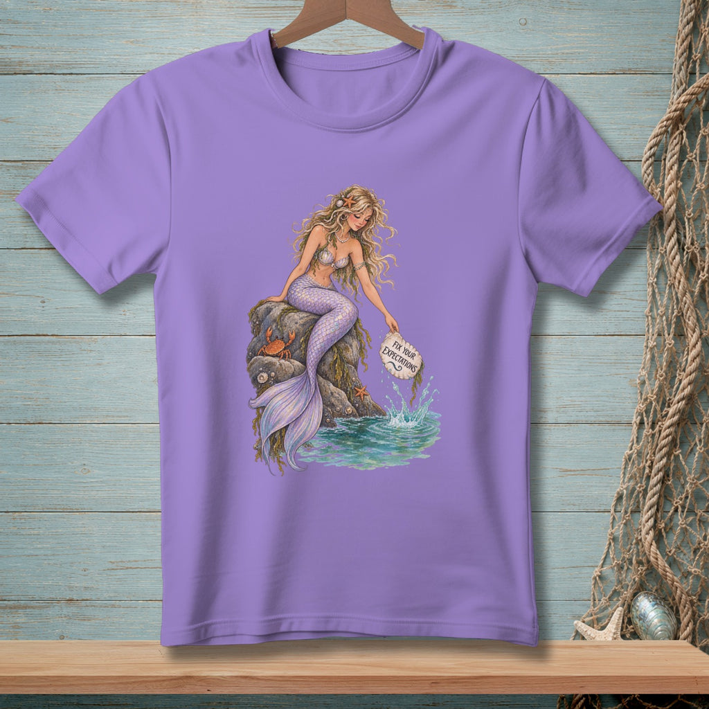 Purple t-shirt with a mermaid sitting on a rock holding a sign that says "Fix Your Expectations."
