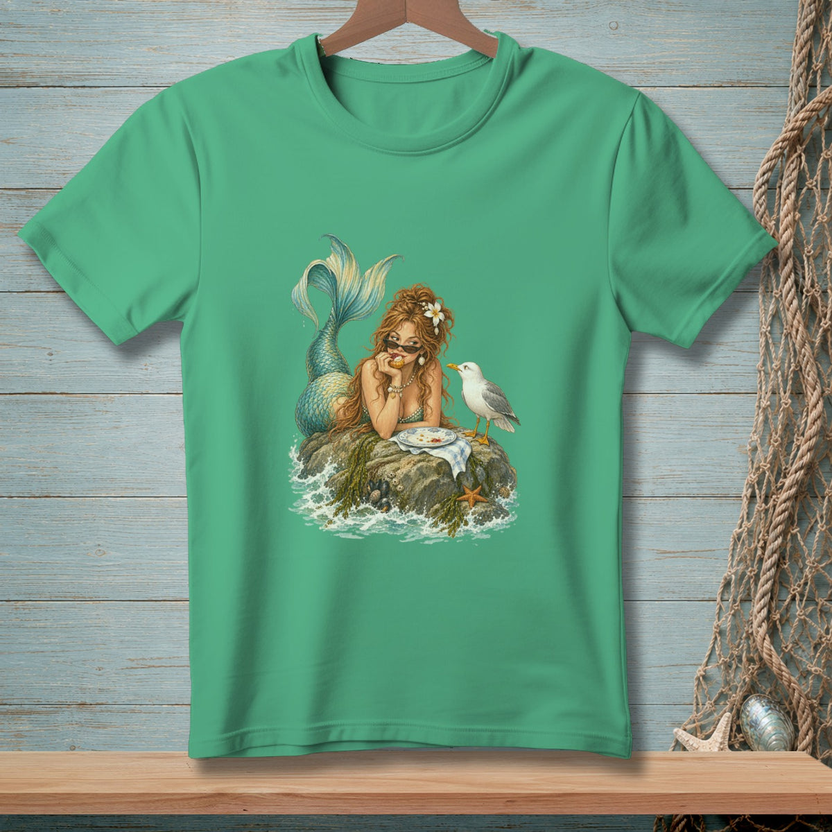 Illustration of a mermaid on a rock sharing food with a seagull.