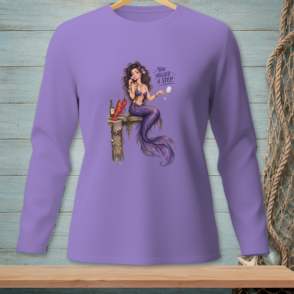 Purple long sleeve shirt with a mermaid, lobster, and wine glass graphic that reads "You Missed A Step".