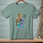 Mermaid holding cocktail on dock with crab and text "This is the effort."