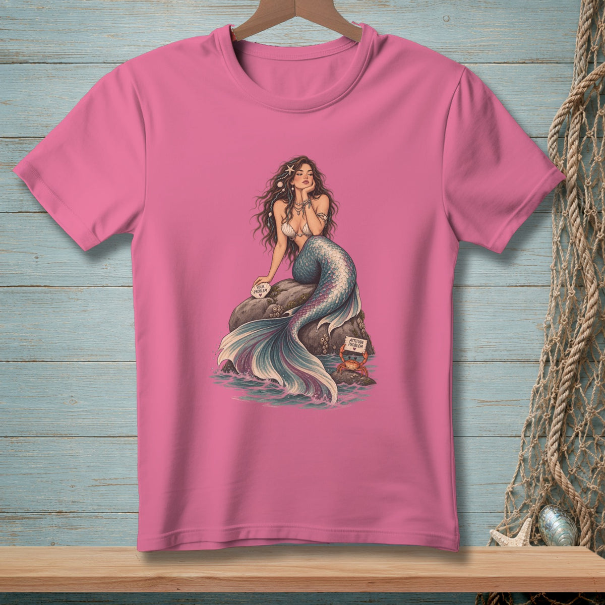 Pink t-shirt with a mermaid on a rock, holding a "Your Problem" sign and a crab with an "Attitude Problem" sign.